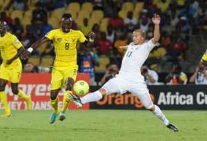 Togo's midfielder Komlan Amewou R clashes with Algeria's midfielder Adlene Guedioura on January 26, 2013.  By Alexander Joe AFP