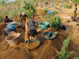 Women in the central Ivorian village of Angovia wash gravel on March 9, 2009, looking for gold.  By Kambou Sia AFPFile