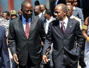 Ivory Coasts Prime Minister Jeannot Ahoussou Kouadio (L) speaks with Sebastien Dano Djedje.  By Sia Kambou (AFP/File)