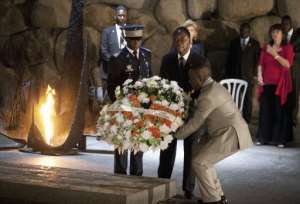 Ivory Coast President Alassane Ouattara (C) lays a wreath in the Hall of Remembrance.  By Menahem Kahana (AFP)