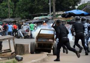 Supporters of former president Laurent Gbagbo run away from police in Abidjan on February 16, 2013..  By Sia Kambou (AFP)