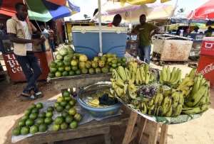 A man sells fruits and vegetables in a market on October 1, 2014 in Monrovia.  By Pascal Guyot AFPFile
