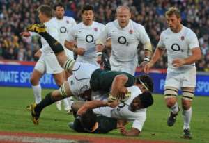 England's Jonathan Joseph is tackled by a South African player.  By Alexander Joe AFP
