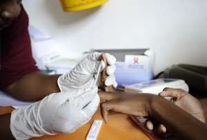 A nurse takes a blood sample on March 8, 2011 in a mobile clinic set up to test students for HIV in Kwazulu Natal, South Africa.  By Stephane de Sakutin AFPFile