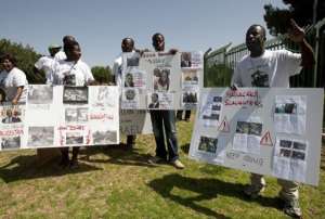 Ivorian Coast opposition activists hold placards and shout slogans during a demonstration outside the Knesset.  By Ahmad Gharabli AFPFile