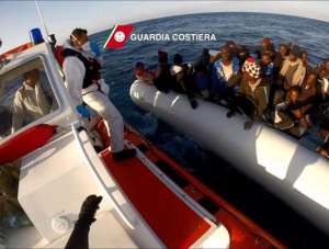In this video grab released by the Italian Guardia Costiera on April 17, 2015 migrants wait in a boat during a rescue operation on April 15 off the coast of Sicily as part of the Triton plan.  By  Guardia CostieraAFP