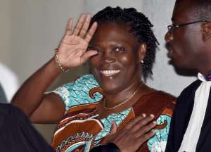 Ivory Coast's former first lady Simone Gbagbo waves as she arrives at the Court of Justice in Abidjan, on February 23, 2015 for her trial.  By Issouf Sanogo AFP