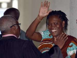Ivory Coast's former first lady Simone Gbagbo waves as she arrives at the Court of Justice in Abidjan, on February 23, 2015 for her trial.  By Issouf Sanogo AFPFile