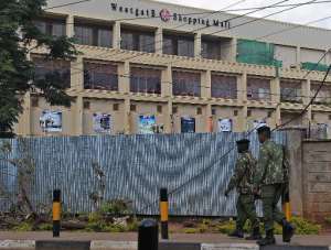 Police officers walk past the Westgate mall in Nairobi on September 28, 2013.  By Tony Karumba AFPFile