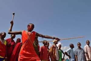A Maasai competitor takes part in the rungu or Maasai club throwing event during the annual 'Maasai Olympics' in the Sidai Oleng Kimana sanctuary in Kimani, Kenya on December 13, 2014.  By Carl De Souza AFP