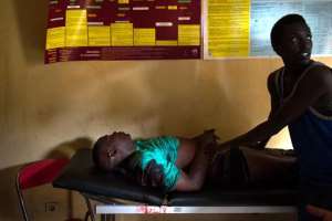 A man identified as Pascal, injured by a gunshot, lies on a gurney in a health centre in the Musaga neighbourhood of Bujumbura, Burundi, on May 4, 2015.  By  AFP