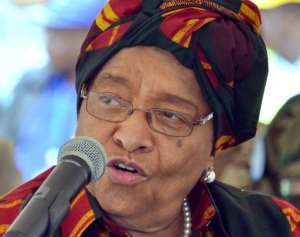 Liberian President Ellen Johnson Sirleaf delivers a speech during the arrival ceremony for the Royal Netherlands Navy Karel Doorman in the port of Monrovia, Liberia, on November 24, 2014 which is delivering Ebola relief supplies.  By Zoom Dosso AFP