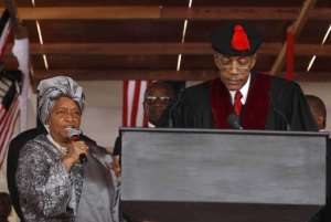 Liberian President Ellen Johnson-Sirleaf L recites the oath of office next to Chief Justice Johnnie Lewis.  By Larry Downing AFPPOOL