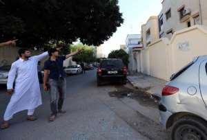 Sons of al-Qaeda suspect Abu Anas al-Libi point at the house next to the scene where he was kidnapped by US special forces in a raid in Nofliene, Libya, on October 6, 2013.  By  AFPFile