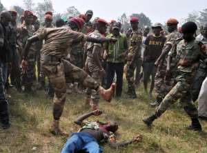 Members of the Central African Armed Forces FACA lynch to death a man suspected of being a former Seleka rebel on February 5, 2014, in Bangui.  By Issouf Sanogo AFP