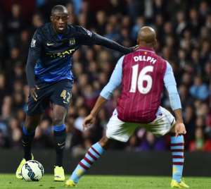 Manchester City's Ivorian midfielder Yaya Toure L runs with the ball in the build up to scoring against Aston Villa, during their English Premier League match, at Villa Park in Birmingham, central England, on October 4, 2014.  By Ben Stansall AFPFile