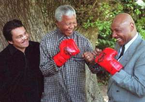 Nelson Mandela pretends to fight former US world middleweight champion Marvin Hagler right at his residence in Cape Town on  November 12, 1997.  By  AFPFile
