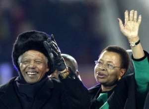 File photo shows South Africa's former President Nelson Mandela L and his wife Graca Machel waving on their arrival for the closing ceremony of the 2010 World Cup in Soweto, suburban Johannesburg on July 11, 2010.  By Thomas Coex AFPFile