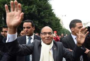 Tunisian President and presidential candidate Moncef Marzouki waves to supporters in Tunis on December 9, 2014. By Fethi Belaid (AFP/File)