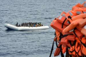 Migrants wait to be rescued off the coast of Libya on November 5, 2016.  By ANDREAS SOLARO (AFP/File)
