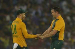 South Africa's captain Faf du Plessis L congratulates Albie Morkel for taking the wicket of India's Bhuvneshwar Kumar during the second T20 at The Barabati Stadium in Cuttack on October 5, 2015.  By Dibyangshu Sarkar AFP