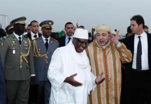 Morocco's King Mohammed VI 2ndR is welcomed by Malian President Ibrahim Boubacar Keita upon his arrival at Bamako airport on February 18, 2014.  By Habibou Kouyate AFP