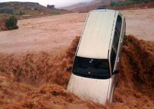 A car is carried away by flood waters in the southern Moroccan region of Ouarzazate, on November 22, 2014.  By - AFP