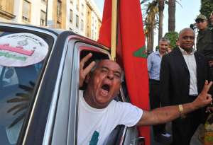 A man shouts for a Yes vote in the forthcoming referendum in Rabat. By Abdelhak Senna (AFP/File)