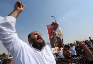 Egyptian supporters of the deposed president Mohamed Morsi carry posters on August 2, 2013.  By Fayez Nureldine AFP