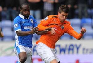 Newcastle Uniteds Davide Santon (R) vies with Wigan Athletics Victor Moses.  By Andrew Yates (AFP/File)