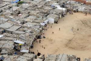 Residents walk in the shanty town of Boa Vista in Luanda, Angola, December 21, 2009.  By Stephane de Sakutin AFPFile