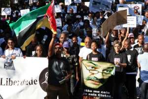 People take part in a march in Maputo, Mozambique, on March 7, 2015, to protest the killing of French-Mozambican lawyer Gilles Cistac.  By Sergio Costa (AFP)