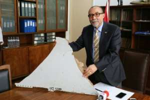 Joao de Abreu, President of Mozambique's Civil Aviation Institute IACM, holds a piece of suspected aircraft wreckage found off the coast of Mozambique at the country's Civil Aviation Institute IACM in Maputo on March 3, 2016.  By Adrien Barbier AFP