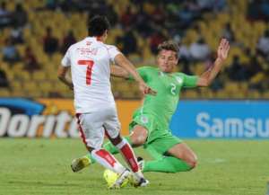 Tunisia's Youssef Msakni L vies for the ball with Algeria's Mehdi Mostefa in Rustenburg on January 22, 2013.  By Alexander Joe AFP