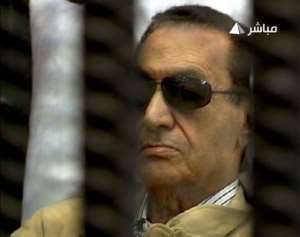 Hosni Mubarak attends his verdict hearing in Cairo.  By  (AFP/Egyptian TV)