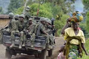 Democratic Republic of Congo soldiers sit at the back of a pick-up truck as they head towards the Mbuzi hilltop, near Rutshuru, on November 4, 2013.  By Junior D. Kannah AFPFile