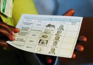 A Zimbabwean voter holds a ballot paper at a polling station in Domboshava, on July 31, 2013.  By Alexander Joe AFPFile