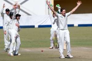 New Zealand bowler Mitchell Santner right and teammates appeal for a wicket on the fifth day of the second Test against Zimbabwe at the Queens Sports Club in Bulawayo on August 10, 2016.  By Jekesai Njikizana AFP