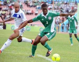 Nigerian defender Elderson Echiejile R fights for the ball with a Rwandan player.  By Pius Utomi Ekpei AFP