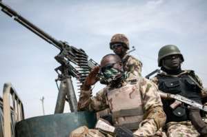 This photo taken on March 25, 2016 shows soldiers from the 7th Division of the Nigerian Army on the back of a vehicle in Damboa, Borno State northeast Nigeria.  By Stefan Heunis AFPFile