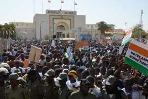 People hold signs during a protest against deadly raids by Boko Haram in front of the National Assembly in Niamey on February 17, 2015.  By Boureima Hama (AFP)