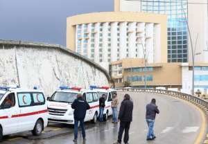 Libyan security forces and emergency services surround Tripoli's central Corinthia Hotel on January 27, 2015.  By Mahmud Turkia AFP