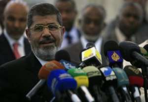 Egyptian President Mohamed Morsi speaks at Khartoum airport on April 5, 2013.  By Ashraf Shazly (AFP/File)