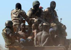 Malian soldiers transport in a pickup truck a dozen suspected Islamist rebels on February 8, 2013 after arresting them north of Gao.  By Pascal Guyot AFPFile