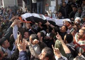 Mourners carry the body of a protester killed in clashes with security forces in Cairo.  By Khaled Desouki AFP