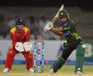 Pakistani batsman Ahmed Shehzd R plays a shot as Zimbabwe wicketkeeper Charles Coventry looks on during the second and final International T20 cricket match between Pakistan and Zimbabwe in Lahore on May 24, 2015.  By Aamir Qureshi AFP