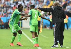 Nigeria's coach Stephen Keshi R and defender Juwon Oshaniwa L congratulate forward Ahmed Musa after he scored a goal during a FIFA World Cup group match, at the Beira-Rio Stadium in Porto Alegre, on June 25, 2014.  By Jewel Samad AFPFile