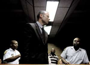 Oscar Pistorius leaves the court room on February 15, 2013 at the Magistrate Court in Pretoria.  By Stephane de Sakutin AFP