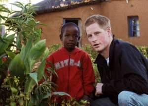 Britain's Prince Harry, seen here with a young boy, in Lesotho, on April 24, 2006.  By John Stillwell PoolAFPFile