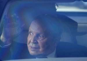 Picture taken on March 3, 2014 in Algiers shows Algerian President Abdelaziz Bouteflika waving from inside a vehicle as he makes a rare appearance to drop off papers for his reelection.  By  AFPFile